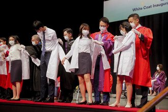 The procession members donned the white coats on freshmen at the Coating Ceremony