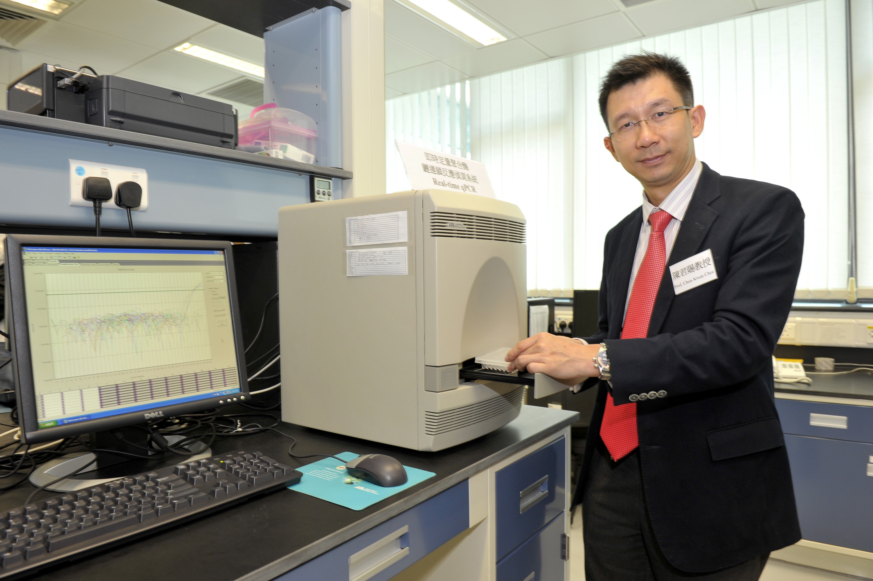 陳君賜教授展示研究計劃所使用的「即時定量聚合酶鏈連鎖反應偵測系統」，可同時間處理近百個血液樣本，測試結果最快在兩小時內得出。