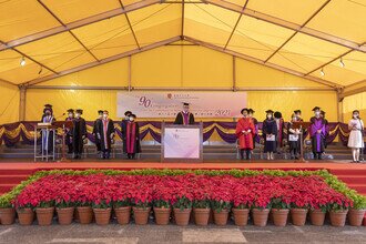 Group photo of procession members on stage 