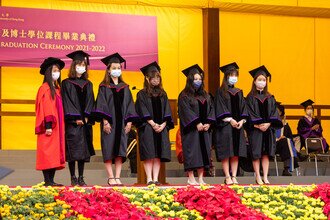 Graduates being blessed and congratulated by Faculty member on stage