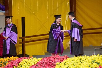 Graduates being blessed and congratulated by Faculty member