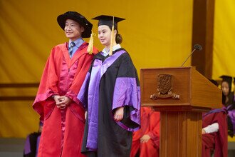 Graduates being blessed and congratulated by Faculty member