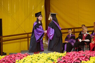 Graduates being blessed and congratulated by Faculty member