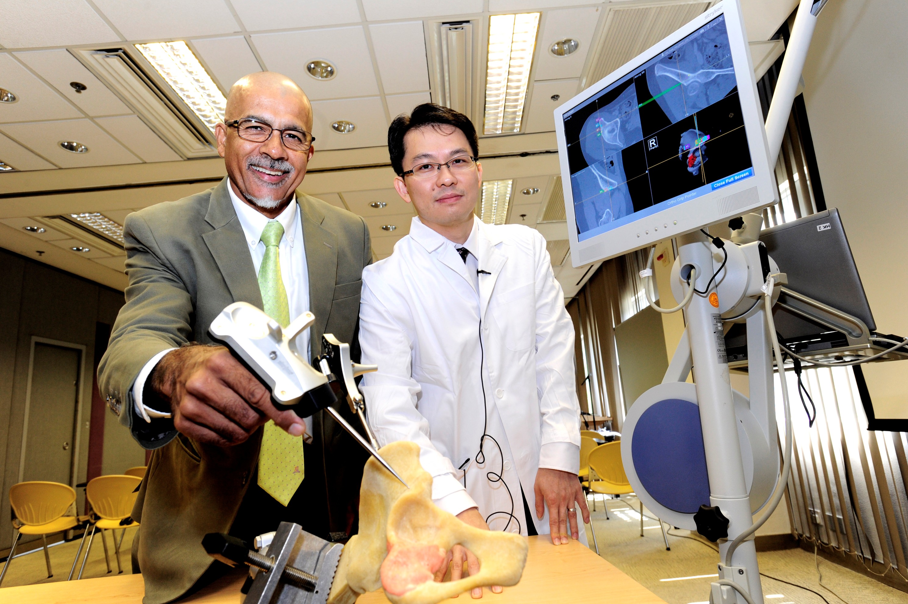 Professor Kumta (left) and Dr. Wong demonstrate the simulation of bone tumor removal surgery.