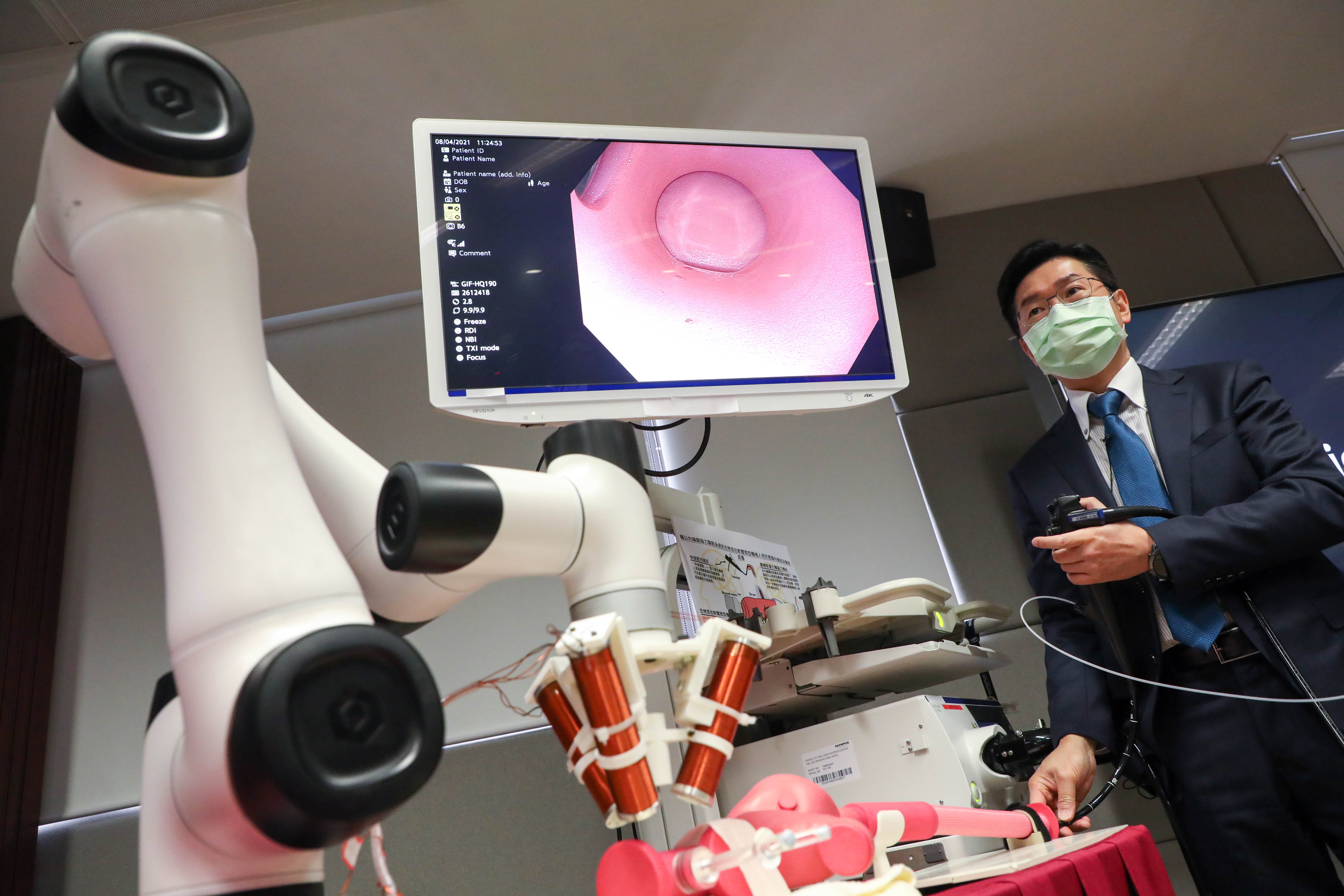 Professor Philip CHIU demonstrates the endoscopic deployment of the microrobots in a human body model